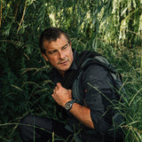 Luminox Bear Grylls Survival Land Men's 43mm Quartz Watch XB.3716 worn on the wrist to show its size and fit. This Bear Grylls Survival Land 3710 Series watch features a sand-coloured dial, an orange crown and a lightweight ALUMI-NOX aluminium case on a black rubber strap.