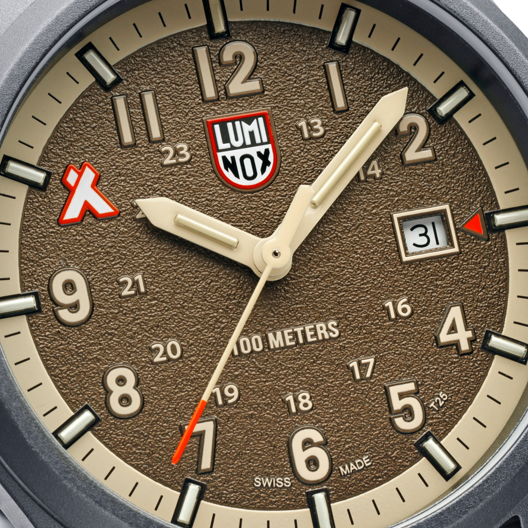 Close-up of the sand-blasted sand-coloured dial on the Luminox Bear Grylls Survival Land Men's 43mm Quartz Watch XB.3716, showing the Bear Grylls logo at 10 o'clock, luminous hands and date window. This Bear Grylls Survival Land 3710 Series watch features 14 self-powered tritium tubes for constant visibility.