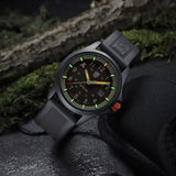 Luminox Bear Grylls Survival Land Men's 43mm Quartz Watch XB.3716 shown in a rugged outdoor adventure setting. This Bear Grylls Survival Land 3710 Series watch features a sand-coloured dial, a lightweight aluminium case and 100m water resistance.