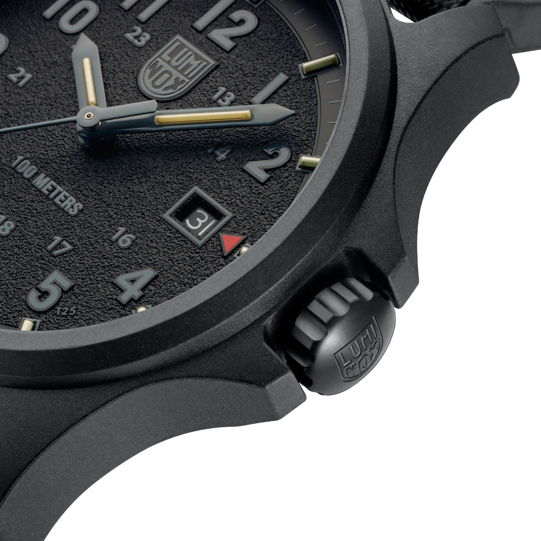 Luminox Atacama Field Men's 43mm Quartz Watch XL.1961 shown in a rugged outdoor setting. This Atacama Field blackout watch features a textured black dial, a lightweight CARBONOX™ case and 100m water resistance.