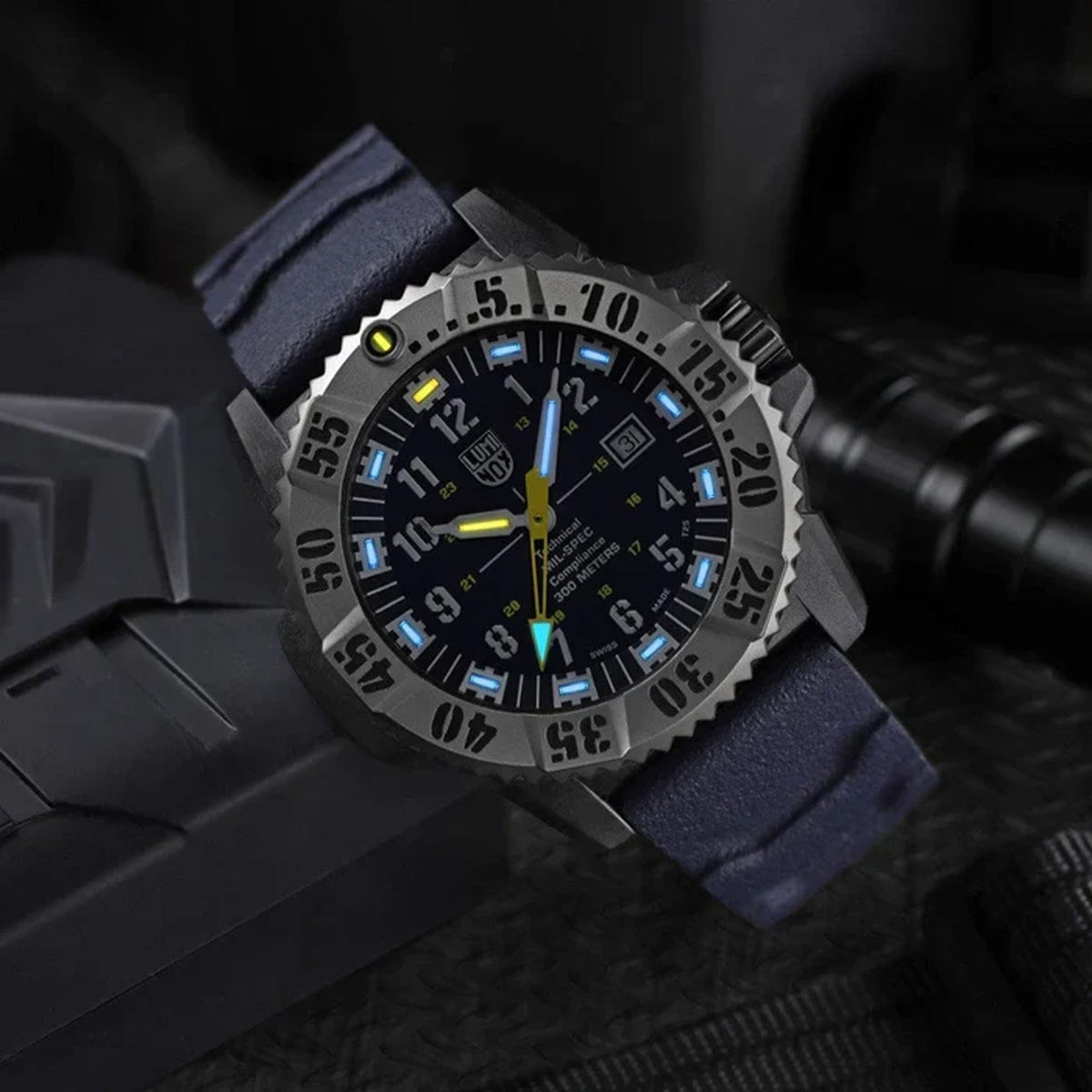 Luminox MIL-SPEC Inspired Men’s 46mm Quartz Watch XL.3355.2 shown in a rugged outdoor setting. This MIL-SPEC 3350 Series military watch features a blue dial, a titanium bezel and 300m water resistance.
