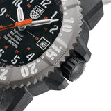 Close-up of the black dial on the Luminox MIL-SPEC Men's 46mm Quartz Watch XL.3359.SET, showing the large orange seconds hand with glowing arrow tip and luminous hands and markers. This MIL-SPEC 3350 Series military watch features self-powered tritium tubes for constant visibility in the dark.