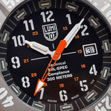 Close-up of the black dial on the Luminox MIL-SPEC Men's 46mm Quartz Watch XL.3359.SET, showing the large orange seconds hand with glowing arrow tip and luminous hands and markers. This MIL-SPEC 3350 Series military watch features self-powered tritium tubes for constant visibility in the dark.