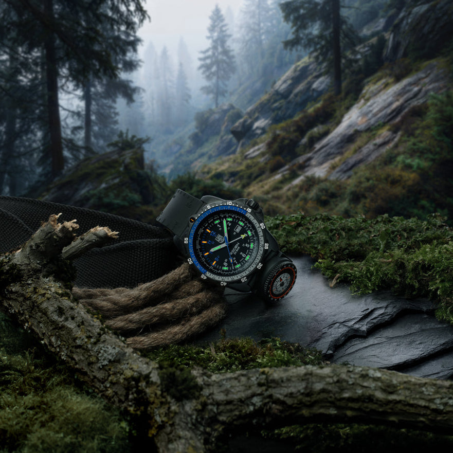 Luminox RECON Nav Spec Men's 46mm Quartz GMT Watch XL.8833 shown in a rugged outdoor navigation setting. This RECON Nav Spec watch features a GMT function, a detachable compass and 200m water resistance.