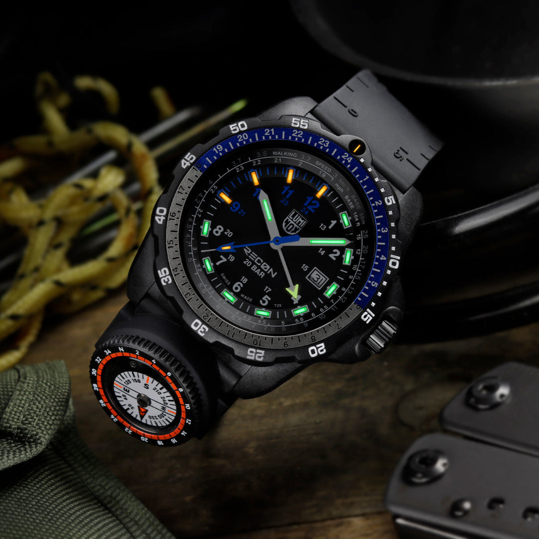 Luminox RECON Nav Spec Men's 46mm Quartz GMT Watch XL.8833 shown in a rugged outdoor navigation setting. This RECON Nav Spec watch features a GMT function, a detachable compass and 200m water resistance.