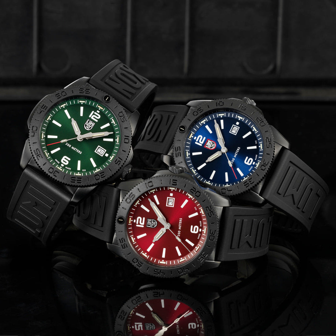 Three Luminox watches with green, blue, and red faces with Black Strap Bands