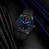 Luminox Pacific Diver Men's 44mm Quartz Watch XS.3123.B shown in a coastal outdoor setting. This Pacific Diver 3120 Series dive watch features an ocean blue sunray dial, a black IP stainless steel case and 200m water resistance.