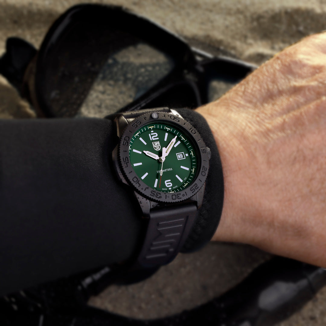 Luminox Pacific Diver Men's 44mm Quartz Watch XS.3137.B worn on the wrist to show its size and fit. This Pacific Diver 3120 Series watch features an emerald green sunray dial, a black CARBONOX™ dive bezel and a black IP stainless steel case on a black rubber strap.