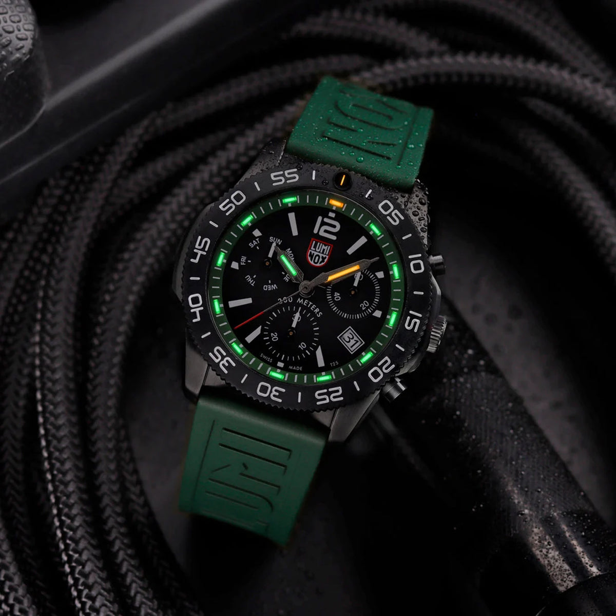 Luminox Pacific Diver Chronograph Men’s 44mm Quartz Watch XS.3147 shown in a forest outdoor setting. This Pacific Diver Chronograph features a forest green dial, a black IP stainless steel case and 200m water resistance.
