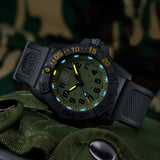 Luminox Navy SEAL Foundation Men's 45mm Quartz Watch XS.3517.NSF.SET shown in a rugged outdoor setting. This Navy SEAL Foundation 3500 Series dive watch features a military green dial, a lightweight CARBONOX™ case and 200m water resistance.