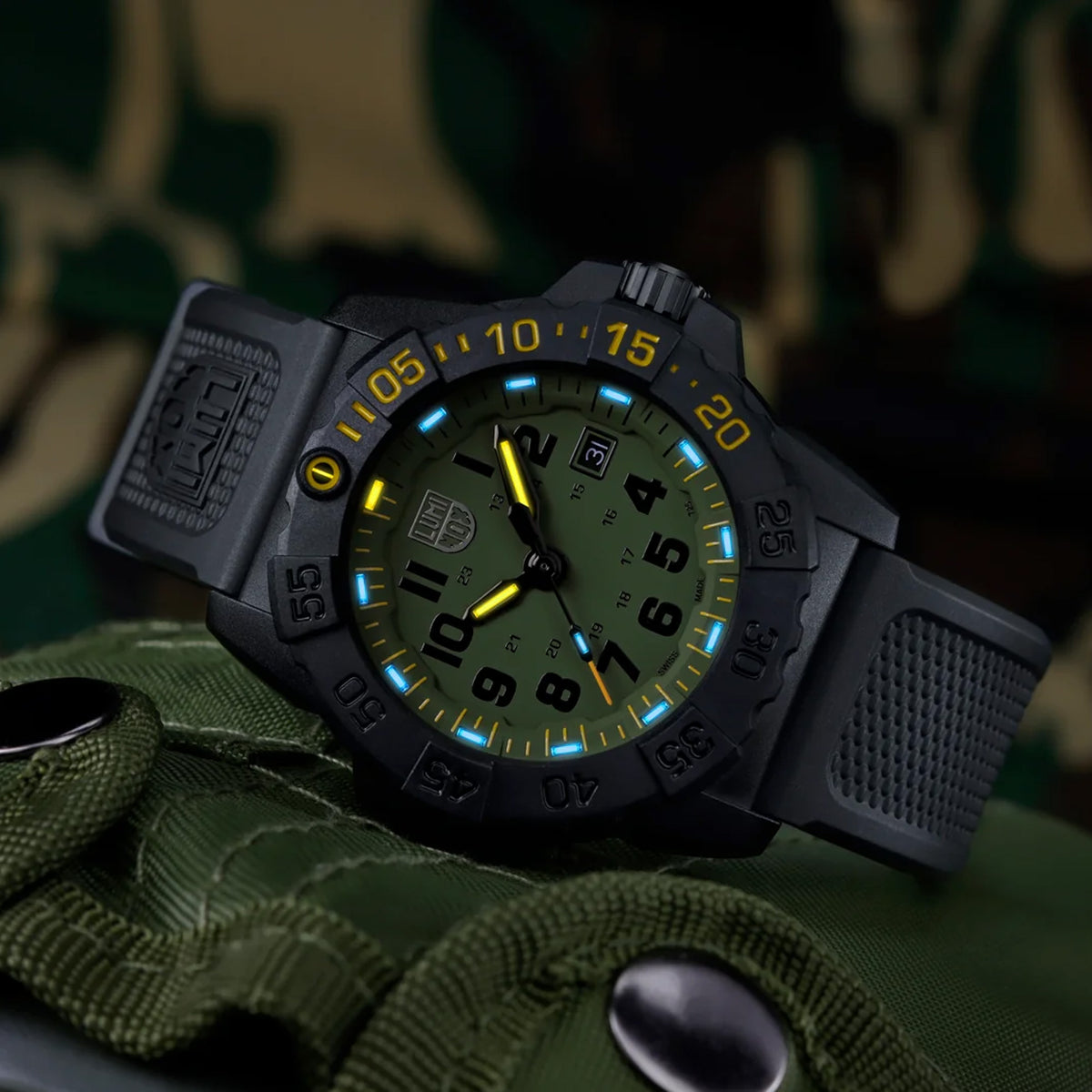 Luminox Navy SEAL Foundation Men's 45mm Quartz Watch XS.3517.NSF.SET shown in a rugged outdoor setting. This Navy SEAL Foundation 3500 Series dive watch features a military green dial, a lightweight CARBONOX™ case and 200m water resistance.