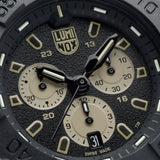 Close-up of the black dial on the Luminox Navy SEAL Chronograph Men’s 45mm Quartz Watch XS.3587, showing the sand-coloured chronograph sub-dials and markers, luminous hands and date window. This Navy SEAL Chronograph 3580 Series watch features self-powered tritium tubes for constant visibility in the dark.