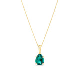 A 9ct yellow gold pendant shown front on, featuring an 8x6mm created emerald in a pear cut, claw set and suspended from a bale. Styled as a May birthstone gift.