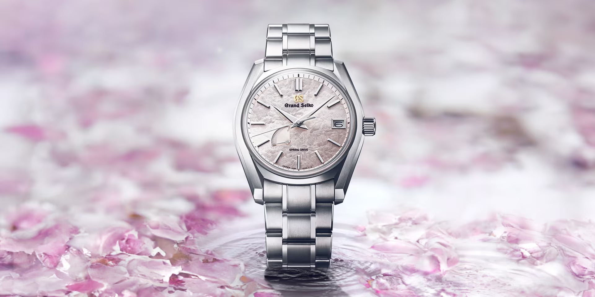 Silver Grand Seiko watch on a pink floral background