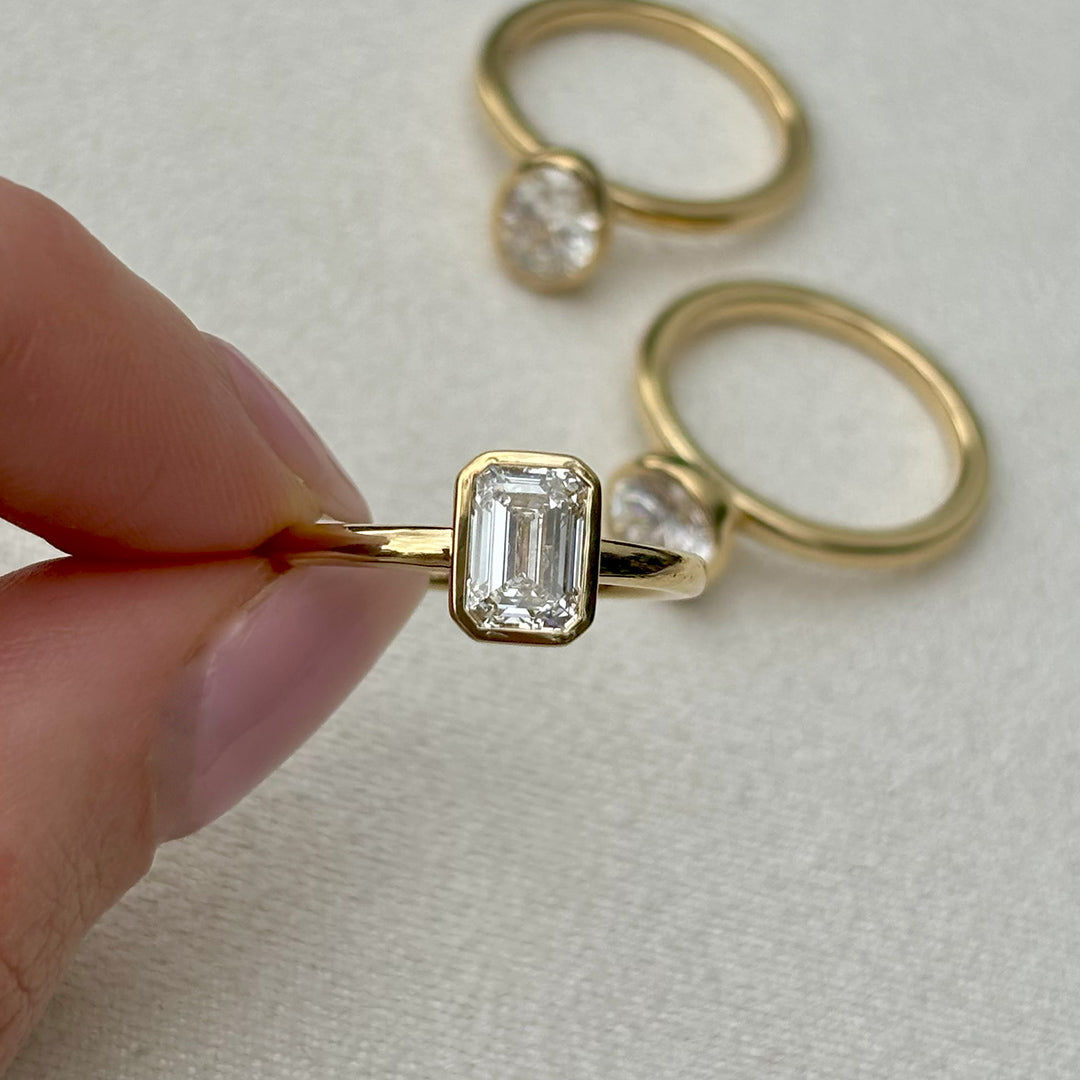 Everlasting 1.25ct TW Emerald Cut Lab-Grown Diamond Bezel Set Solitaire Engagement Ring in 18ct Yellow Gold