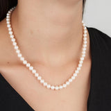 Woman wearing Freshwater Pearl Strand Necklace with gold clasp