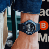 Casio G-SHOCK DW6900U-1D digital sport watch with black resin band, triple graph display, and shock-resistant design on wrist