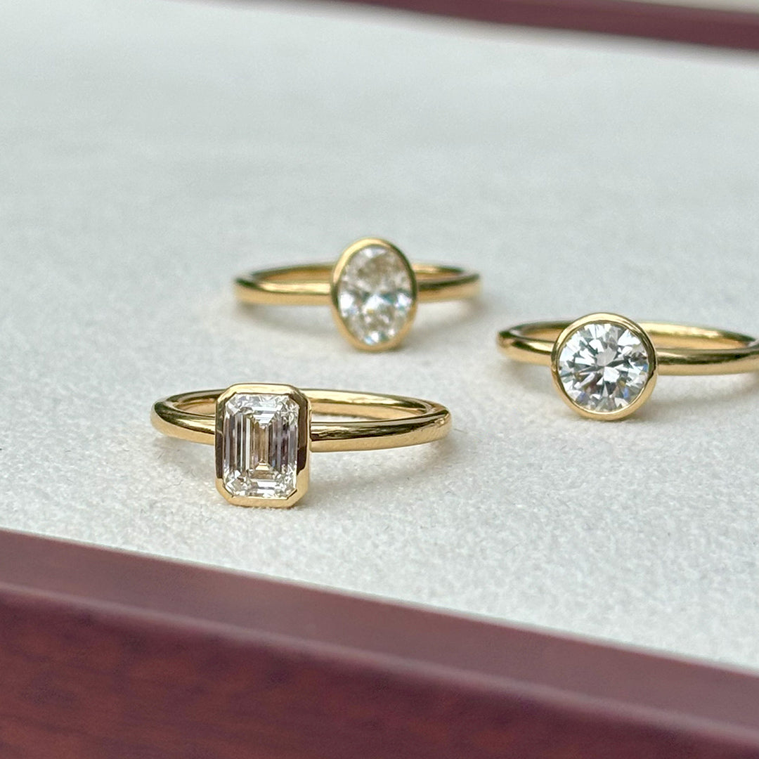 Everlasting 1.25ct TW Emerald Cut Lab-Grown Diamond Bezel Set Solitaire Engagement Ring in 18ct Yellow Gold