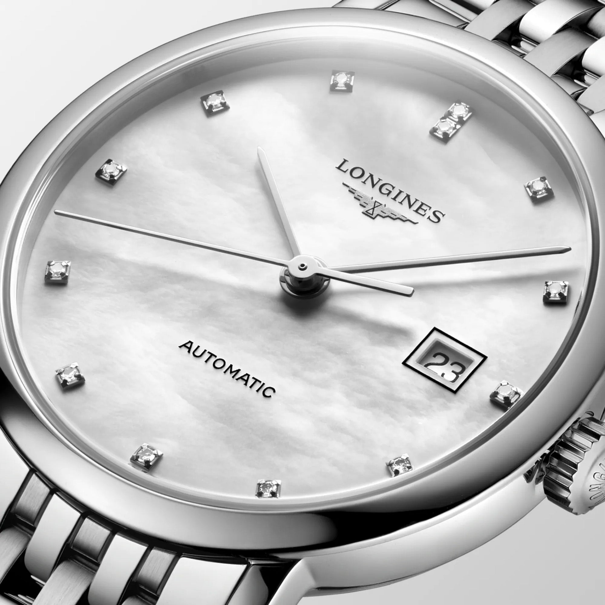 Dial close-up of the Longines Elegant Automatic L4.310.4.80.6, featuring a luminous white mother-of-pearl finish with sparkling diamond hour markers and a date window at 3 o'clock. The slim polished hands and sapphire crystal give the watch a refined, contemporary look.