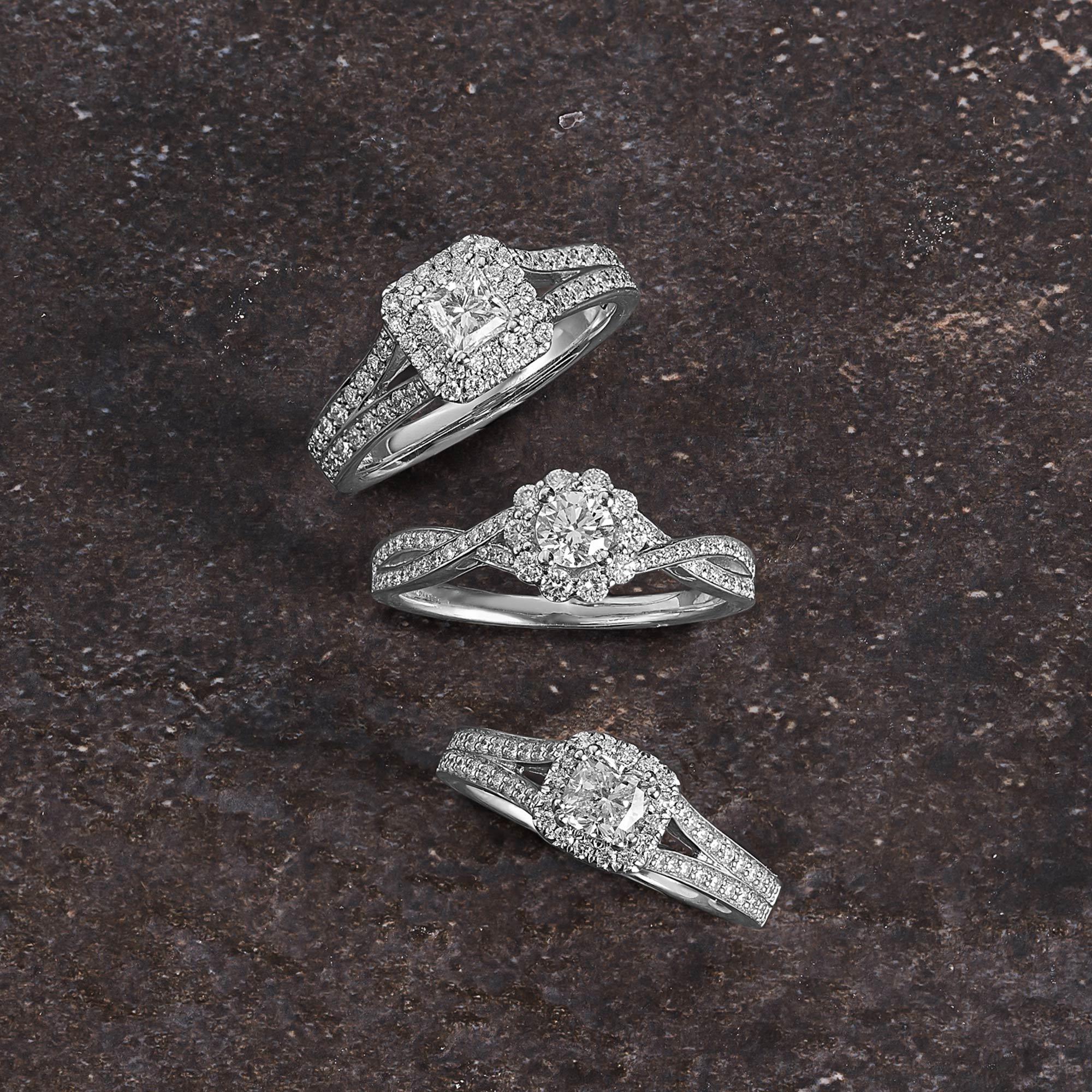 Three White Gold Solitaire Rings with Diamond Halo and Bands.