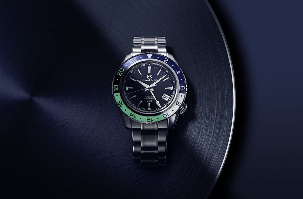 Grand Seiko watch with a dark face and colorful bezel