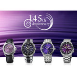 Four wristwatches displayed side by side against a purple gradient background with a white '145th Anniversary' logo at the top. The watches feature purple and blue dial faces with silver and black metal cases and straps.
