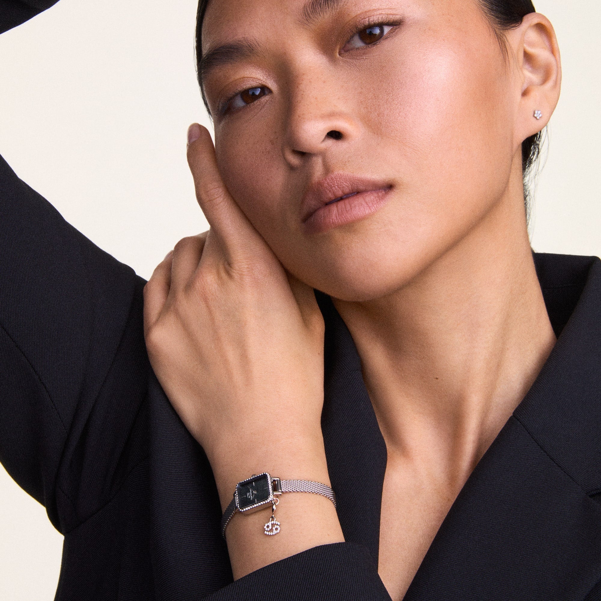 Woman wearing a Daniel Wellington Watch with a silver mesh band.