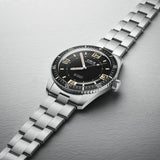 Close-up of the black dial on the Oris Sixty Five Automatic Men's 40mm Watch 733 7772 4034SET, showing the large luminescent numerals and retro Oris logo. The polished bezel and case finish are shown in detail.