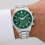 The Loyal Academy Steel Chronograph Watch worn on the wrist, showing the true scale of the 40mm case and green chronograph dial. The stainless steel finish and matching bracelet give this quartz watch a sporty, versatile look for daily wear.