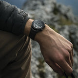 The Raymond Weil Freelancer GMT Worldtimer Men's 40.5mm Automatic Watch 2765-BKC-20001 worn on the wrist, showing its all-black look and size. The black DLC case and leather strap give this Swiss travel watch a modern, understated style.
