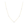 A delicate gold chain necklace featuring five evenly spaced, small white pearl beads, displayed on a clean white background.