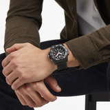 Luminox Navy SEAL Chronograph Men's 45mm Quartz Watch XS.3581 worn on the wrist to show its size and fit. This Navy SEAL Chronograph 3580 Series watch features a black dial with three sub-dials, a black rotating dive bezel and a lightweight CARBONOX™ case on a black rubber strap.