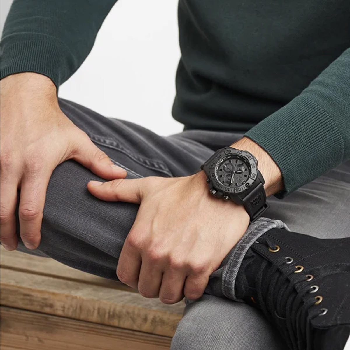 Luminox Navy SEAL Men's 45mm Black Quartz Chronograph Watch XS.3581.BO worn on the wrist to show its size and fit. This Navy SEAL Chronograph Blackout watch features a black dial with three sub-dials, a black dive bezel and a lightweight black CARBONOX™ case on a black strap.