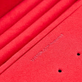 Close-up of a red WOLF jewellery box with 'Lustrology'