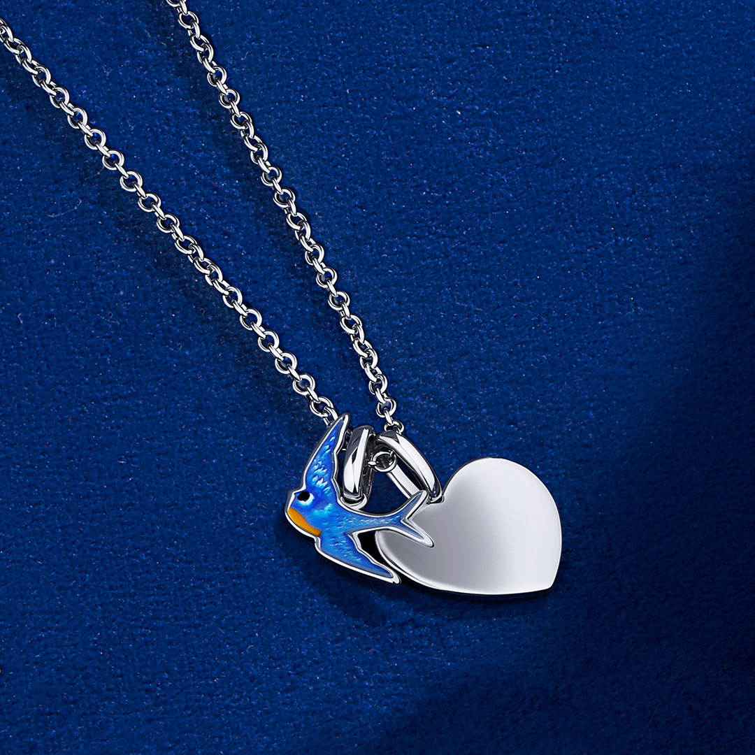 Flat lay view of the Wallace Bishop Bluebird of Happiness Heart Pendant in Sterling Silver, reference 49NKBB01, laid flat on a 400mm (approximately 15.7 inch) cable chain. The pendant features a small blue enamel bird with a separate polished silver heart.