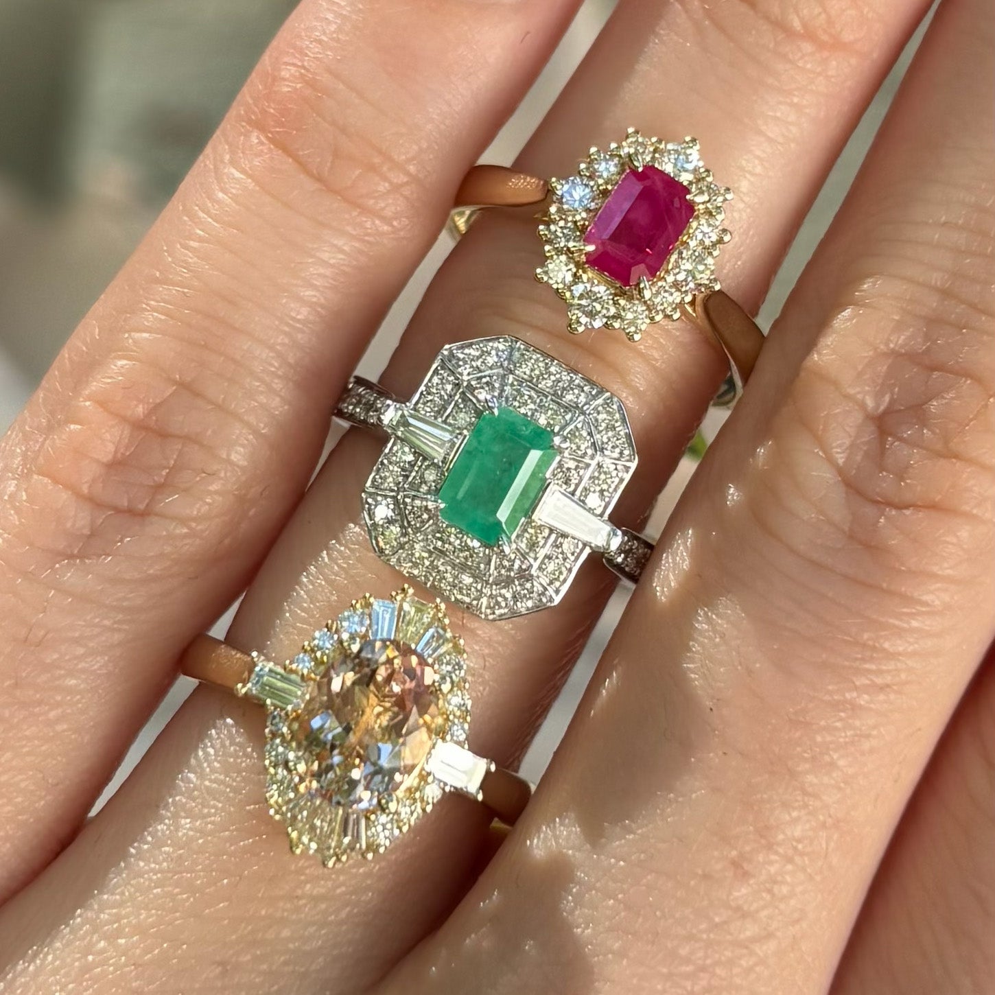 Three rings with gemstones on a hand
