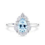 1917™ aquamarine and 0.52ct TW diamond halo engagement ring in 18ct white gold, photographed front on. The pear cut aquamarine centre stone is surrounded by a halo of marquise and round brilliant cut diamonds on a plain polished band.