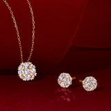 Flat lay view of the Wallace Bishop 0.24 TDW Round Diamond Heart Prong Pendant in 9ct Yellow Gold, reference 3PBB239Y, on a cable chain with a parrot clasp, laid flat with the 0.25 TDW Round Diamond Heart Prong Stud Earrings in 9ct Yellow Gold, reference 3EBB239Y. The pendant features a cluster of nine claw-set natural round diamonds framed by small heart-shaped prong details, and each earring features a similar cluster of claw-set diamonds.