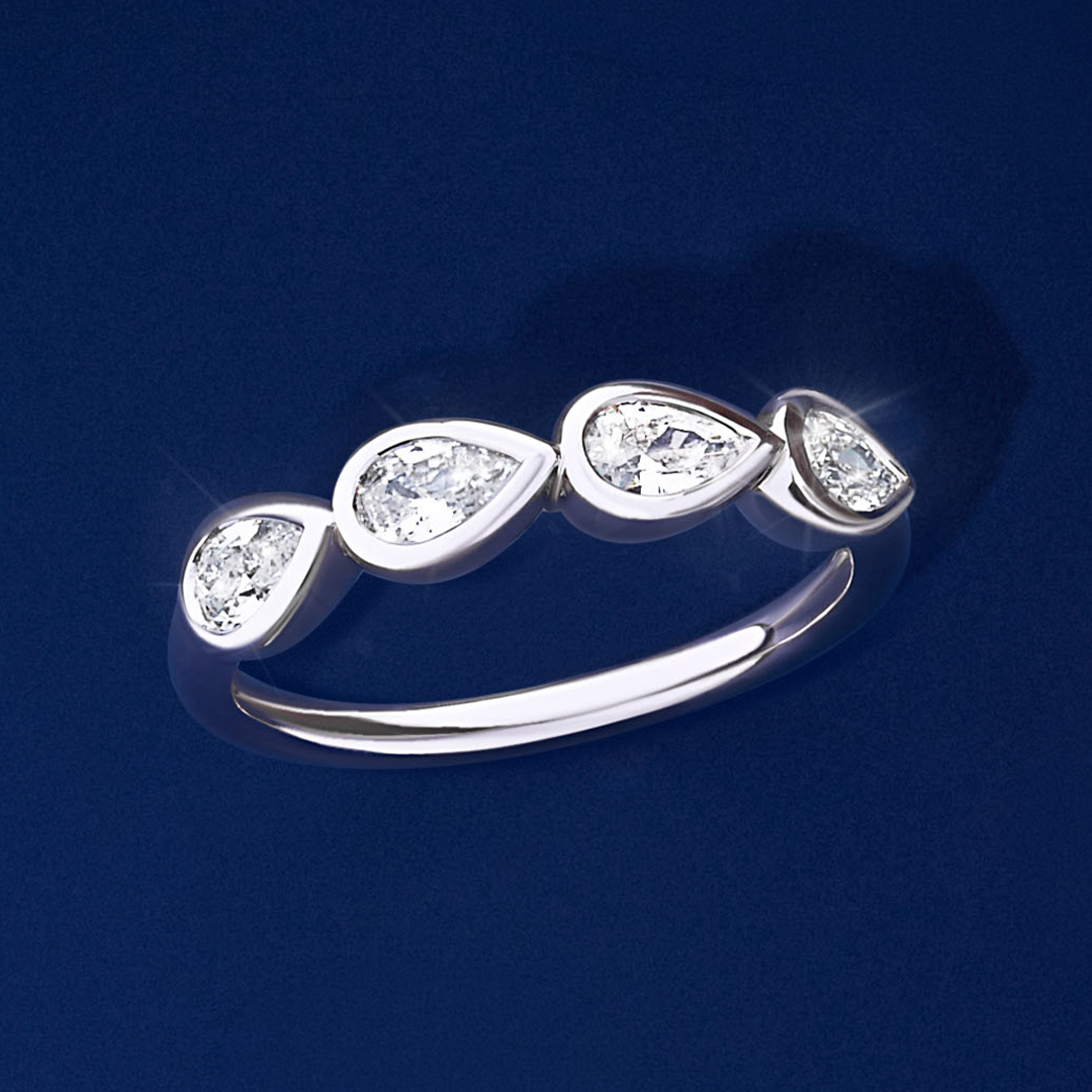 Front-on view of the Wallace Bishop Cubic Zirconia Bezel Ring in Sterling Silver, reference 41PSBCZR2O, on a plain polished band. The ring features four bezel-set pear cut white cubic zirconias, each measuring 5x3mm.
