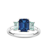 Front-on view of the Wallace Bishop Cubic Zirconia Trilogy Ring in Sterling Silver, reference 41RCZD01R, on a polished band. The ring features a large light blue emerald cut cubic zirconia centre stone, flanked by two smaller mint coloured emerald cut cubic zirconias, all claw set.