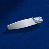 Flat lay view of the Wallace Bishop Bluebird of Happiness ID Plate Brooch in Sterling Silver, reference 49BRBB01, measuring 33mm in length, laid flat. The engravable plate features a bluebird finished in blue enamel.
