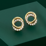Flat lay view of the Wallace Bishop Cubic Zirconia Circles Stud Earrings in 9ct Yellow Gold, reference 68ECZ500, measuring 9 x 7.50mm, laid flat. Each earring features two interlocking circles, one in plain polished gold and one set with round cubic zirconias.