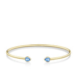 Front-on view of the Wallace Bishop London Blue Topaz Flexi Bangle in 9ct Yellow Gold, reference 93BGLTBY, a cuff-style bangle measuring 50mm by 60mm. The bangle features a bezel-set 5x4mm natural pear-cut London blue topaz on each side.