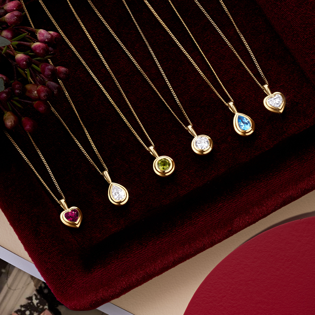 Five Wallace Bishop double bezel pendants in 9ct Yellow Gold shown in a row: the Round Peridot, reference 93PDRDPE1Y, the Pear-Cut Swiss Blue Topaz, reference 93PDPSST1Y, and the 0.30 TDW Lab-Grown Diamond pendants in round, reference LGNDBR30, pear-cut, reference LGNDBP30, and heart, reference LGNDBH30.