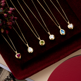 Five Wallace Bishop double bezel pendants in 9ct Yellow Gold shown in a row: the Round Peridot, reference 93PDRDPE1Y, the Pear-Cut Swiss Blue Topaz, reference 93PDPSST1Y, and the 0.30 TDW Lab-Grown Diamond pendants in round, reference LGNDBR30, pear-cut, reference LGNDBP30, and heart, reference LGNDBH30.