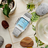 Casio Vintage AQ230A-2A1 watch front view, featuring a rectangular octagonal stainless steel case with polished silver-tone bezel, clean ice blue dial with slim line indices, analogue hands, and a lower digital LCD window displaying time and day-date.