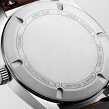 Close-up of a Longines watch case with branding and model number engraving 