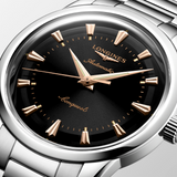 Silver Longines watch with black dial on a light gray background - 4