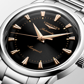 Silver Longines watch with black dial on a light gray background - 4