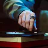 The Casio Ring Watch Digital 25mm Watch CRW001-1D worn on the finger to show scale and fit. The stainless steel case and dimpled band detailing sit neatly as a wearable, functional timepiece.